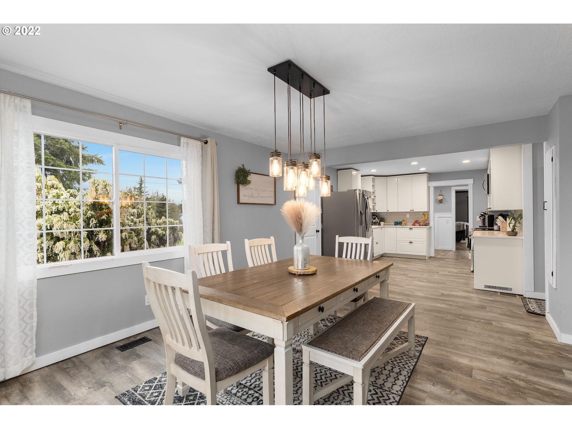 12275 Southeast School Avenue Boring, OR 97009 - Photo 7 of 14 a view of a dining room with furniture window and wooden floor