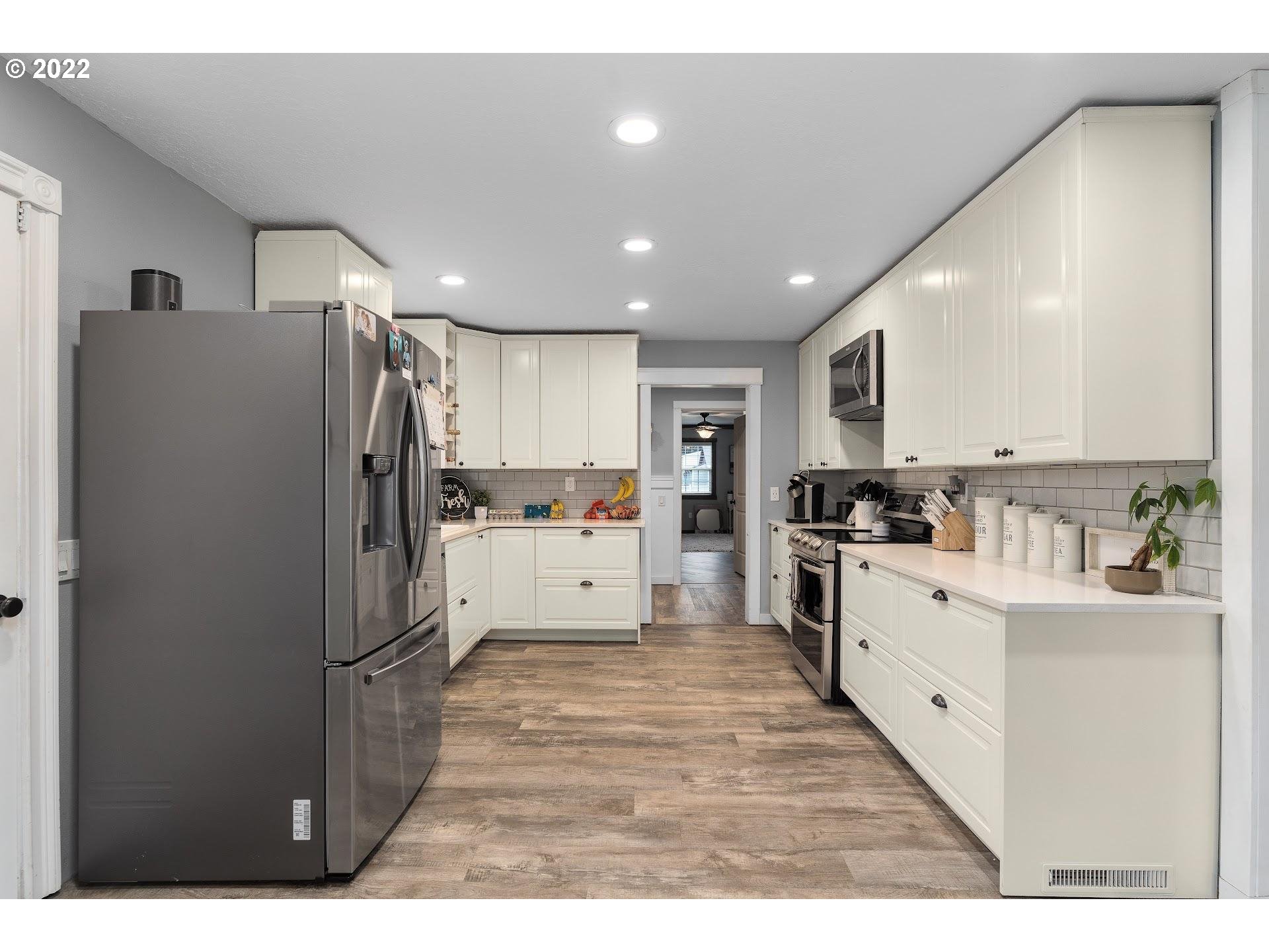 12275 Southeast School Avenue Boring, OR 97009 - Photo 8 of 14 a kitchen with refrigerator and cabinets