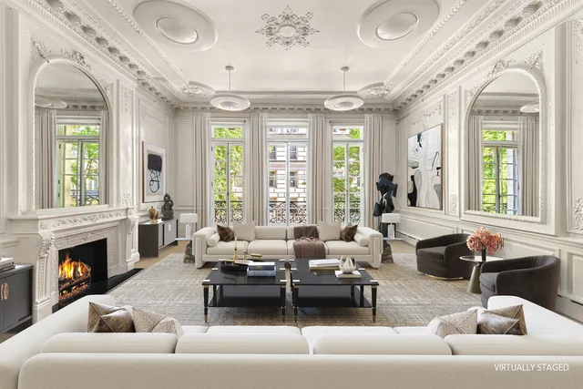 a living room with furniture a fireplace and a table