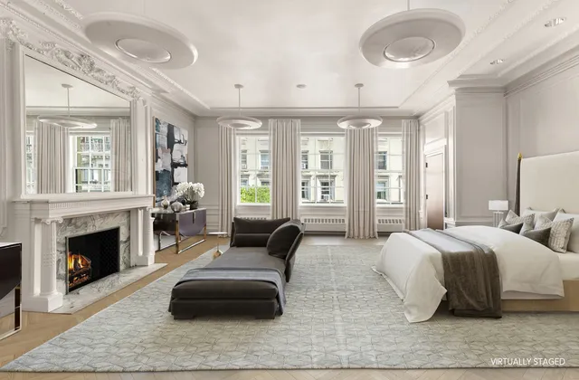 a living room with furniture a fireplace and a large window