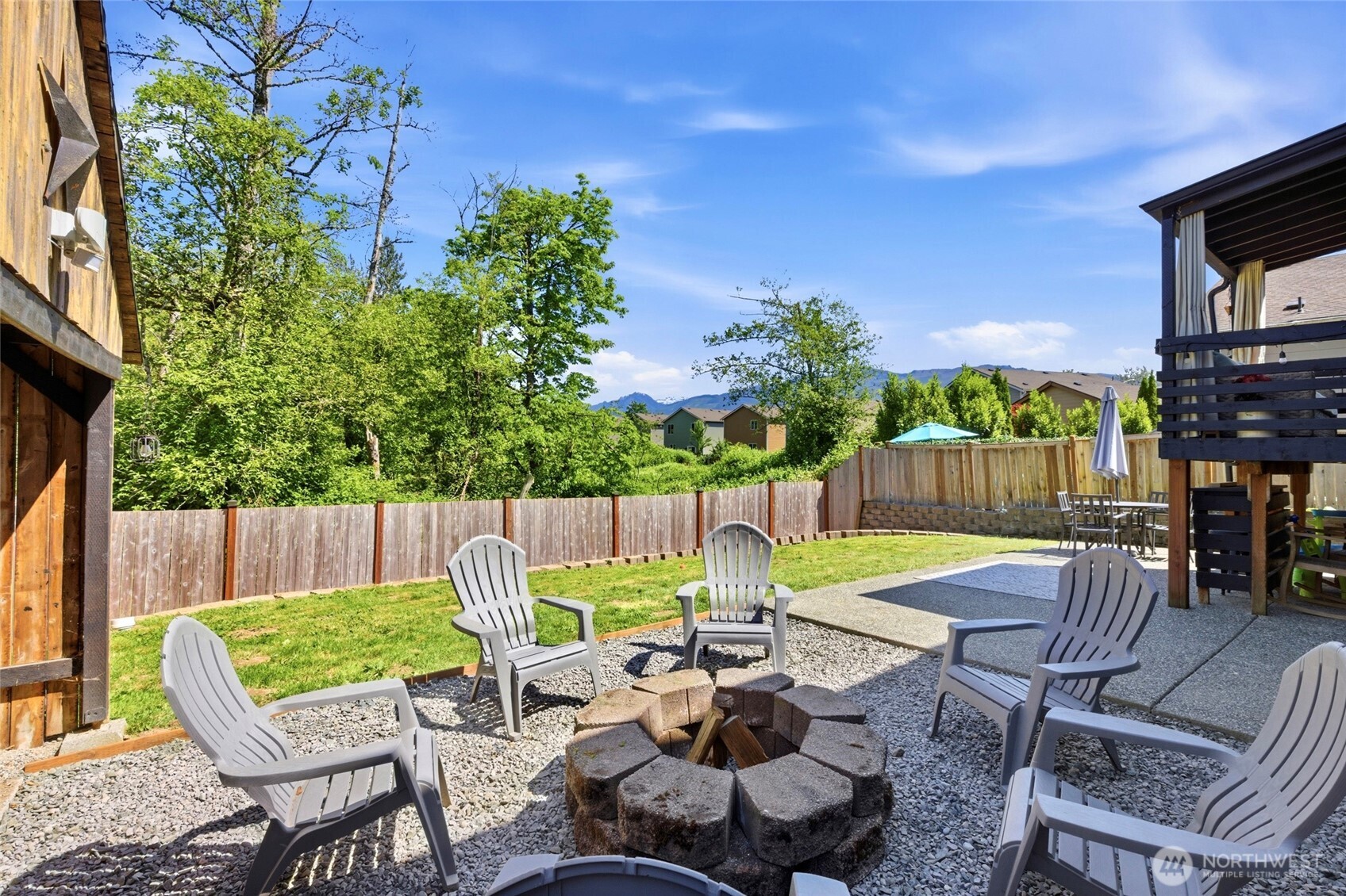 14005 Cedar Court Sultan, WA 98294 - Photo 35 of 38 a view of a patio with table and chairs potted plants with wooden fence