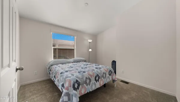 a bedroom with a bed and a fireplace