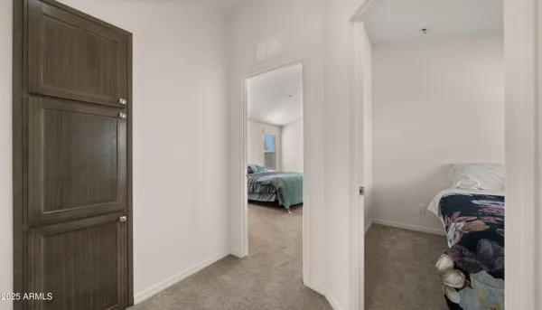 a walk in closet with view of bedroom