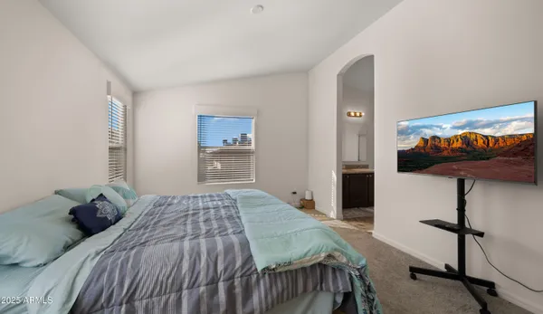 a bedroom with a bed and ceiling fan