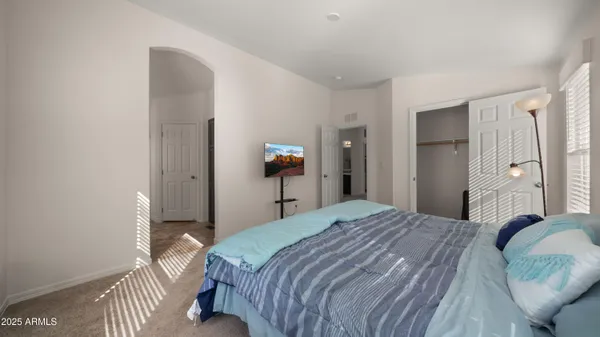 a bedroom with a bed and a mirror