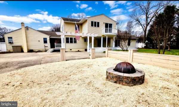 a view of a white house with a yard and garage