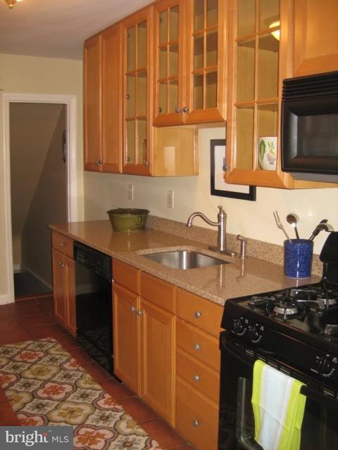 225 Overbrook Road Baltimore, MD 21212 - Photo 12 of 28 a kitchen with a sink stove and cabinets