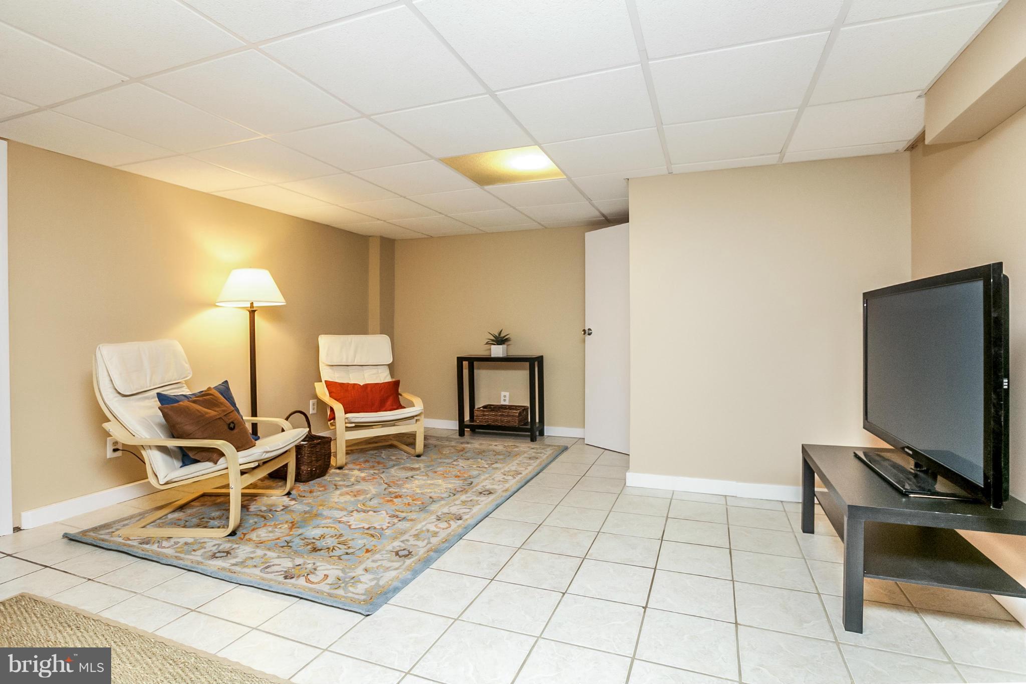 225 Overbrook Road Baltimore, MD 21212 - Photo 13 of 28 a living room with furniture and a flat screen tv