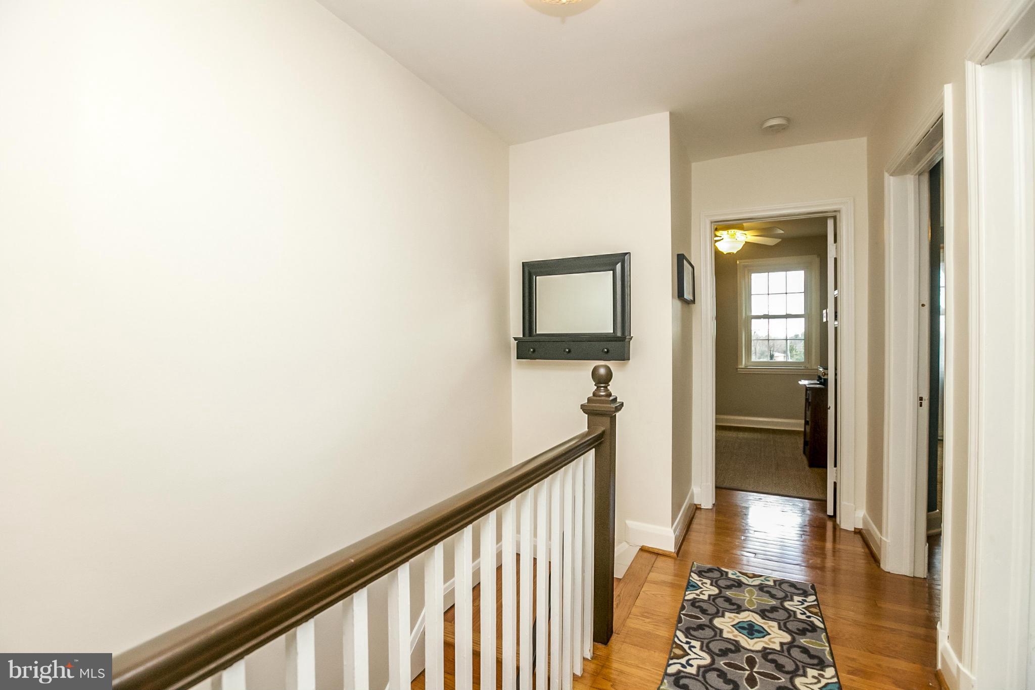225 Overbrook Road Baltimore, MD 21212 - Photo 16 of 28 a view of a hallway with wooden floor and a bathroom
