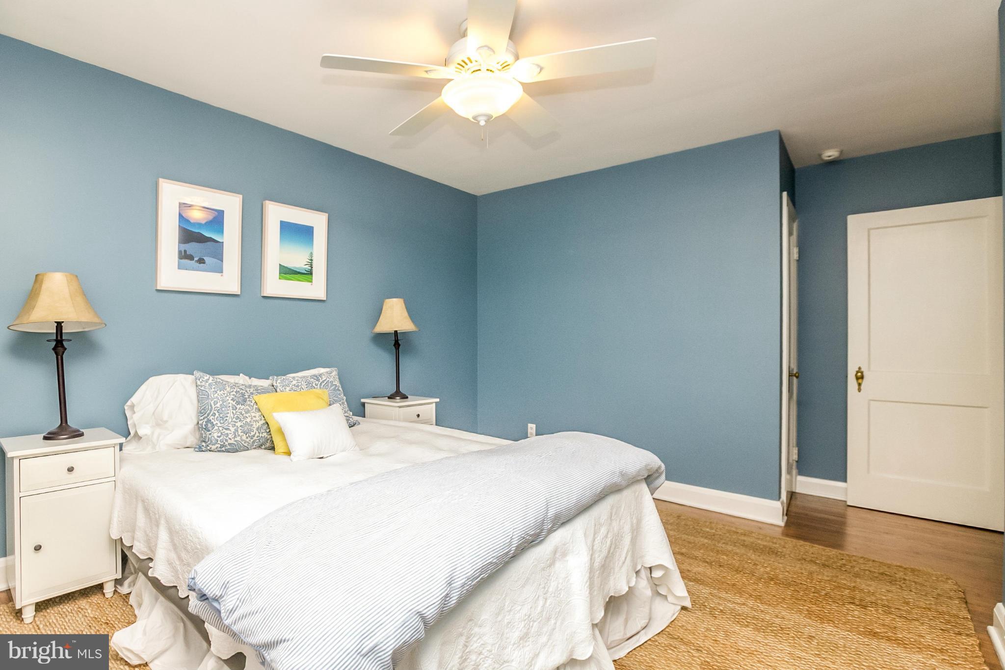 225 Overbrook Road Baltimore, MD 21212 - Photo 18 of 28 a bedroom with a bed and a potted plant