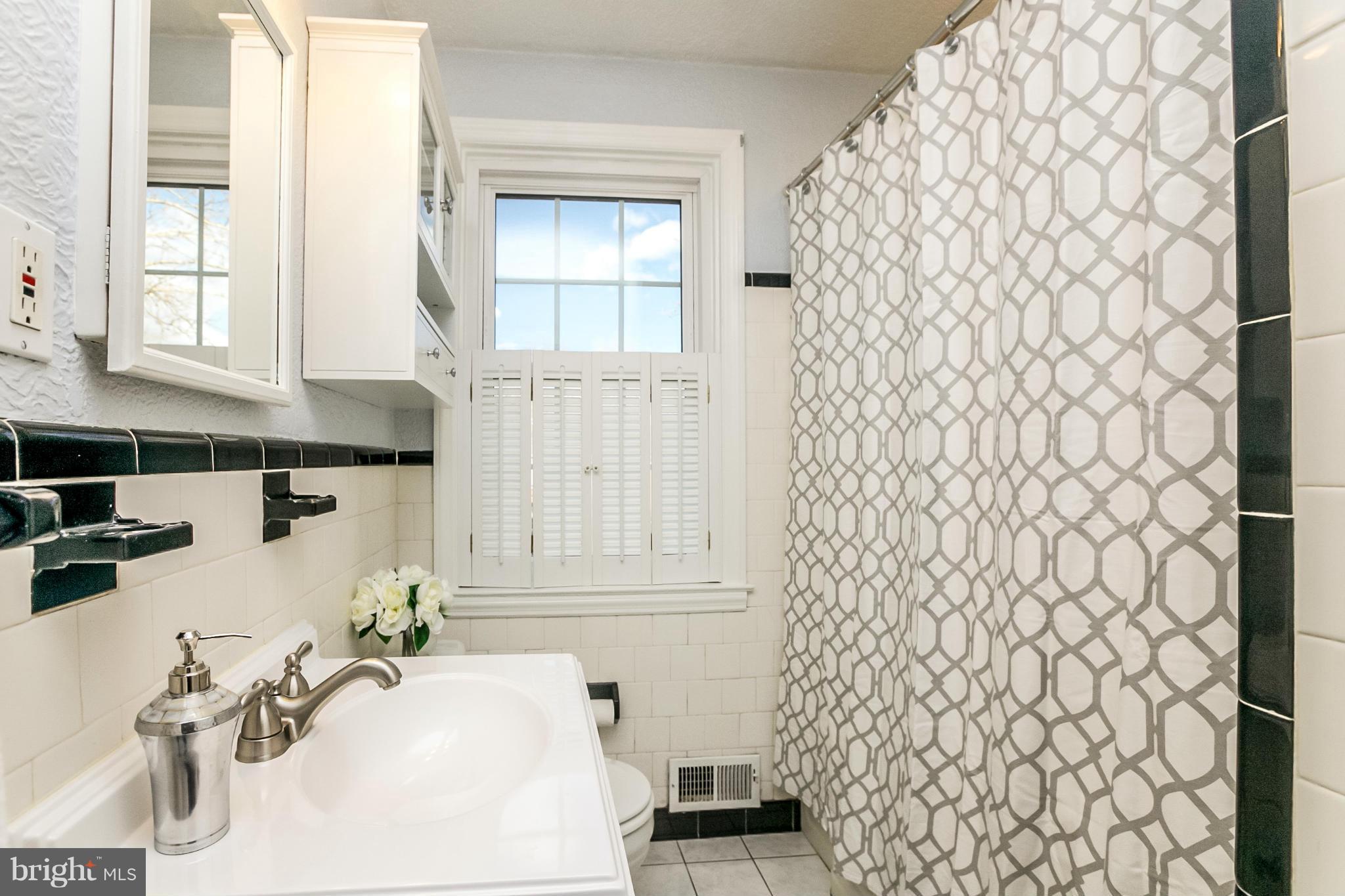 225 Overbrook Road Baltimore, MD 21212 - Photo 19 of 28 a bathroom with a sink and a mirror