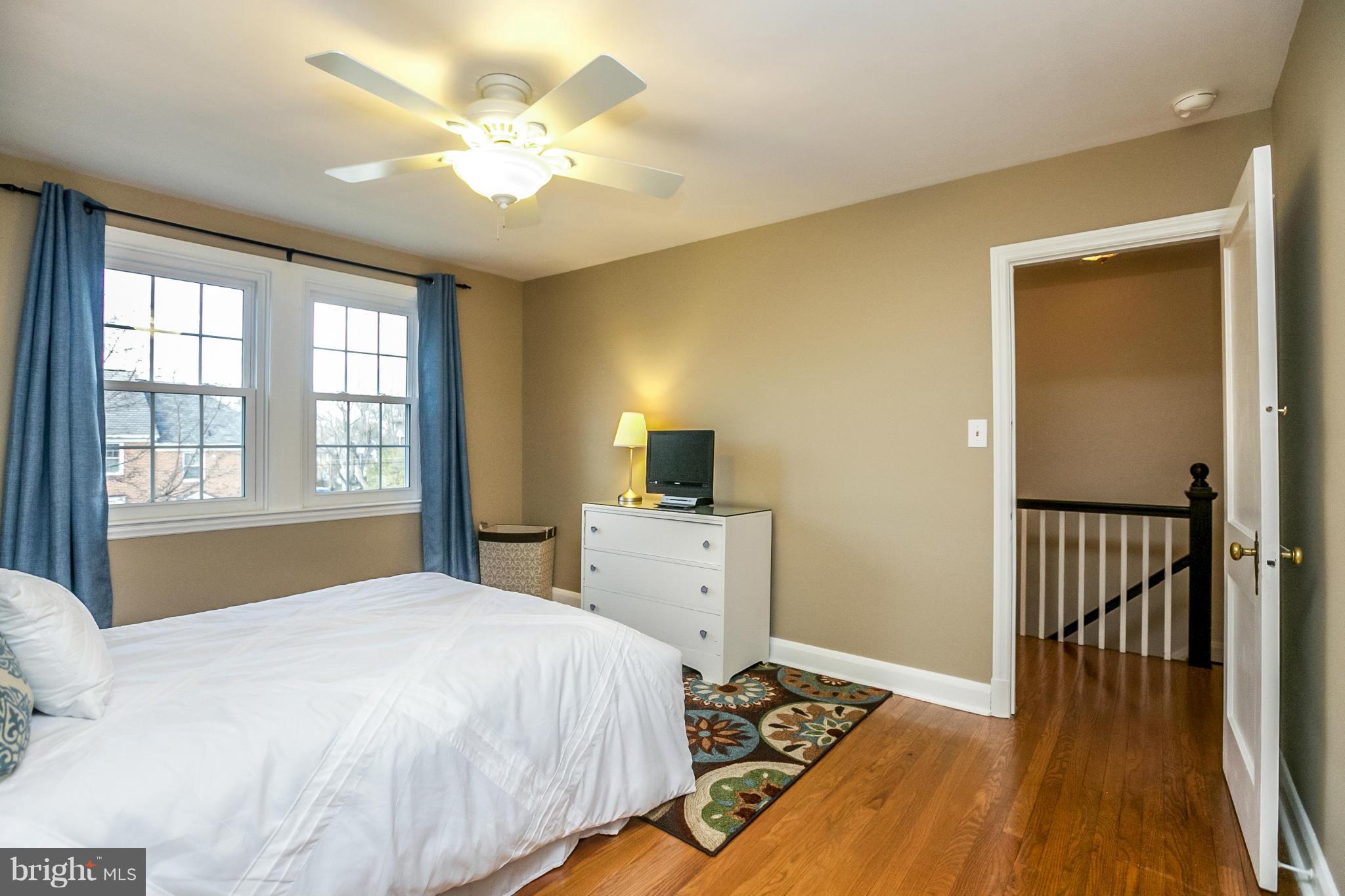 225 Overbrook Road Baltimore, MD 21212 - Photo 20 of 28 a bedroom with a bed and a chandelier