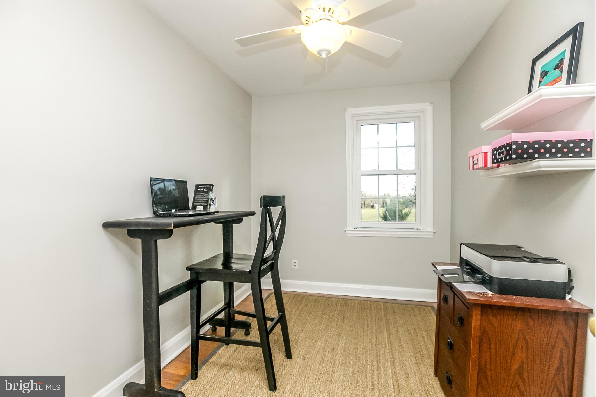 225 Overbrook Road Baltimore, MD 21212 - Photo 22 of 28 a view of a workspace with furniture and a window
