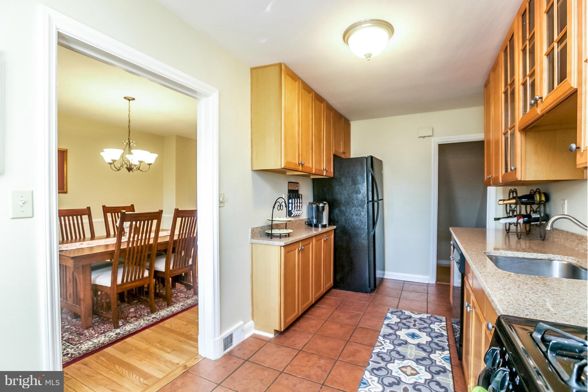 225 Overbrook Road Baltimore, MD 21212 - Photo 10 of 28 a kitchen with stainless steel appliances granite countertop a refrigerator a stove and a sink with large cabinets