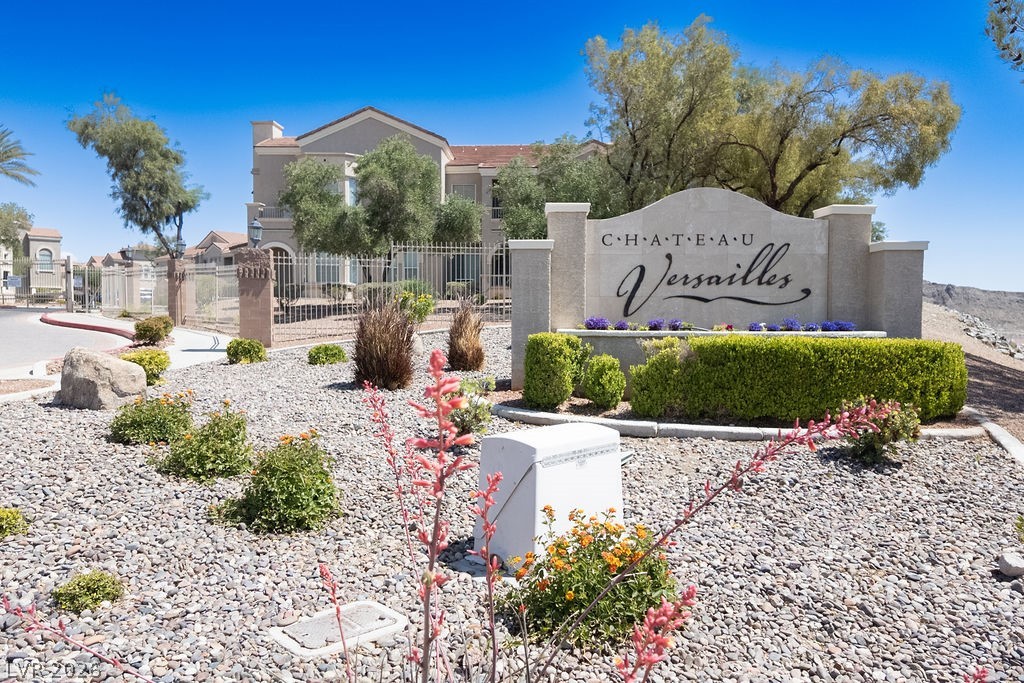 10550 West Alexander Road, Unit 2133 Las Vegas, NV 89129 - Photo 13 of 42 Enter a gated community featuring a grand entrance and well-maintained grounds.