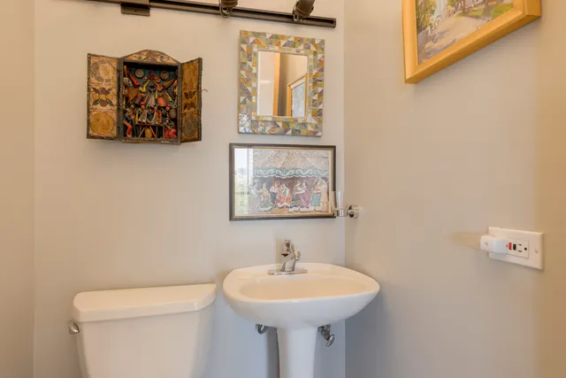 a bathroom with a sink and mirror with toilet