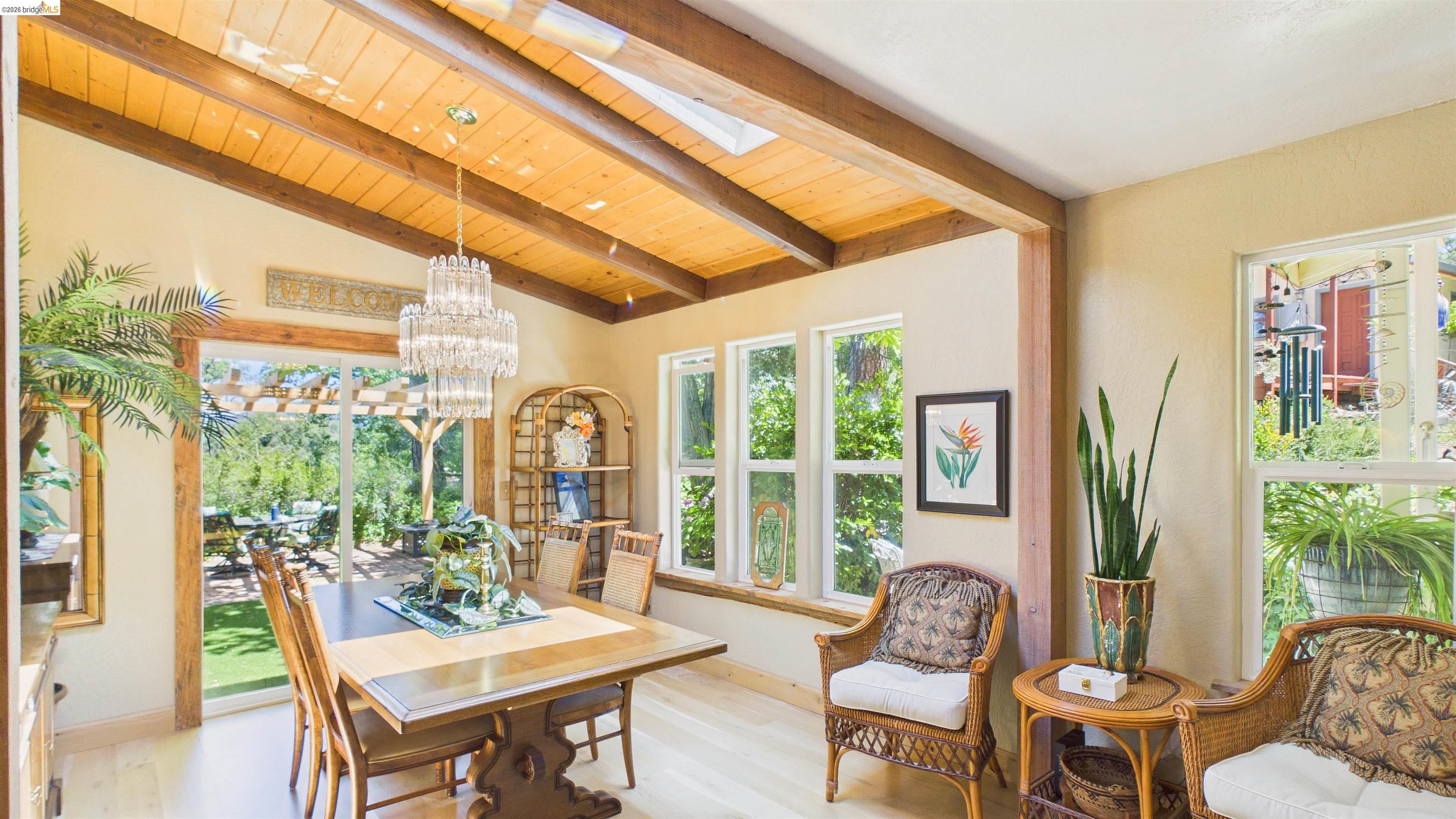 18102 Mt Eaton Road Tuolumne, CA 95379 - Photo 5 of 44 Vaulted wood-paneled ceiling with exposed beams and central chandelier