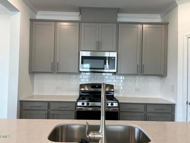 a kitchen with granite countertop a stove and a sink