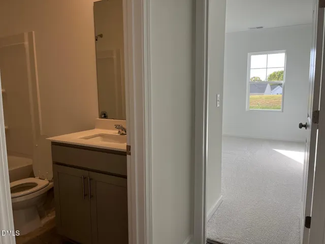 a bathroom with a sink toilet and vanity