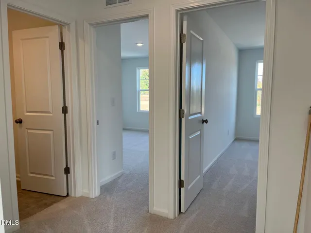 a view of a hallway with two rooms