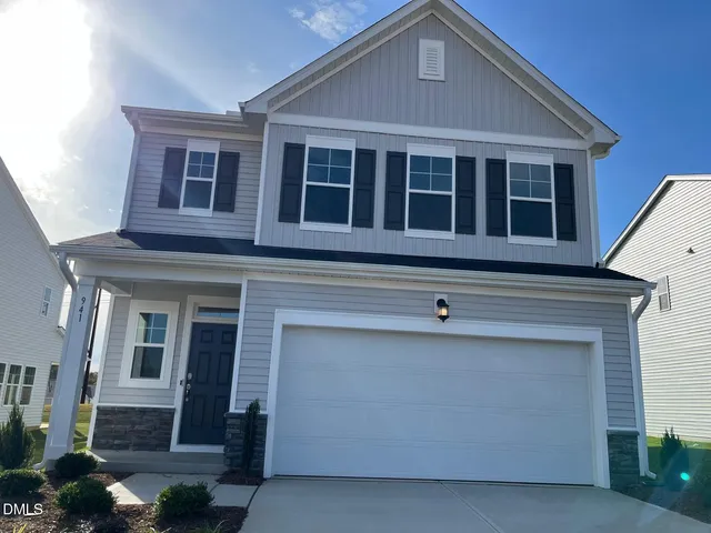 a front view of a house with a garage