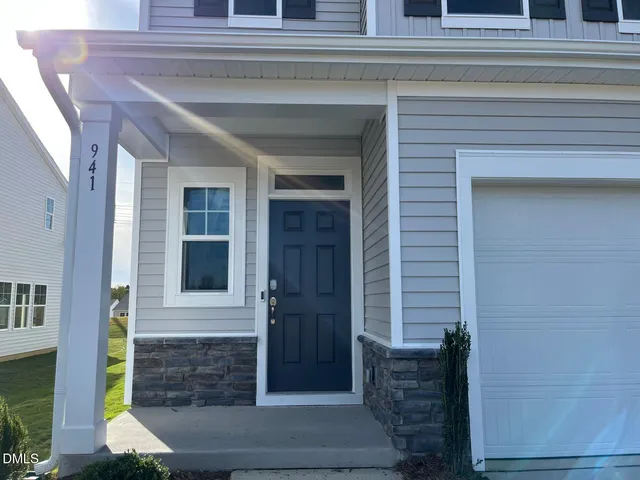 a front view of a house with a potted plant