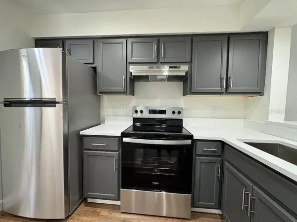 a kitchen with stainless steel appliances a refrigerator stove and sink