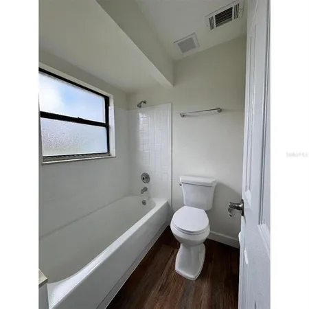 a bathroom with a toilet and a bathtub