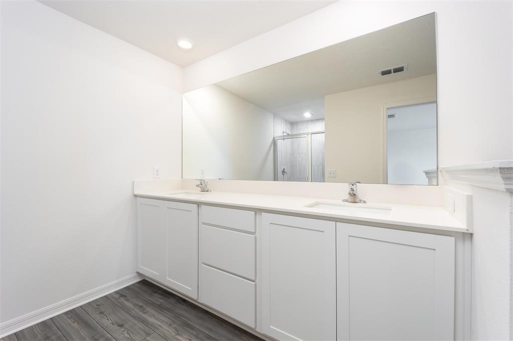 745 Poppy Lane Dundee, FL 33838 - Photo 11 of 16 a bathroom with a sink and a mirror