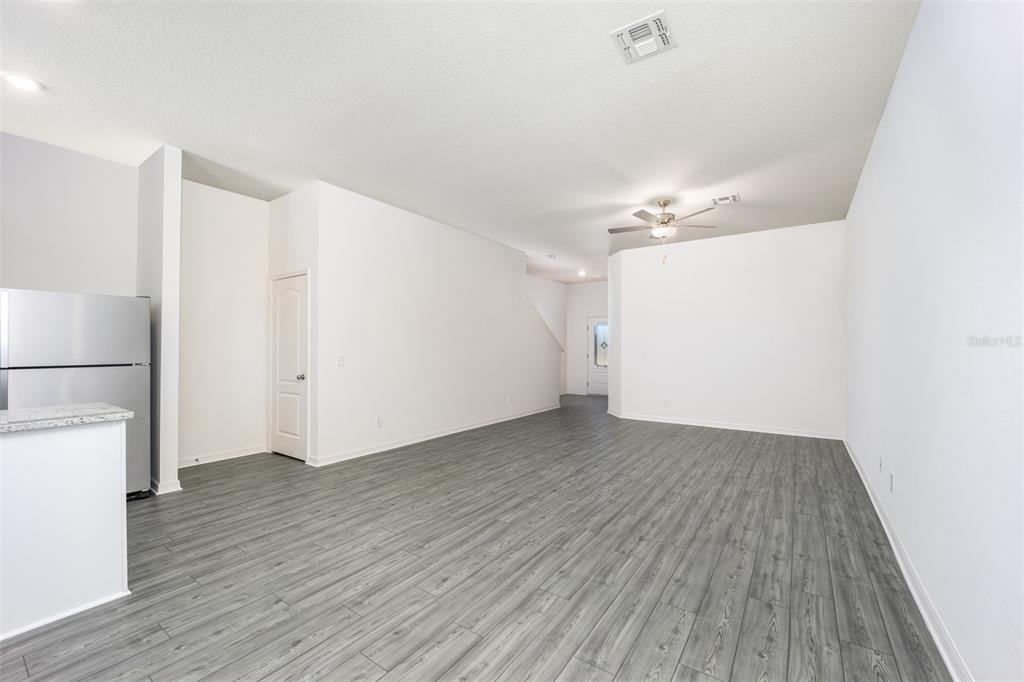 745 Poppy Lane Dundee, FL 33838 - Photo 7 of 16 a view of a room with wooden floor