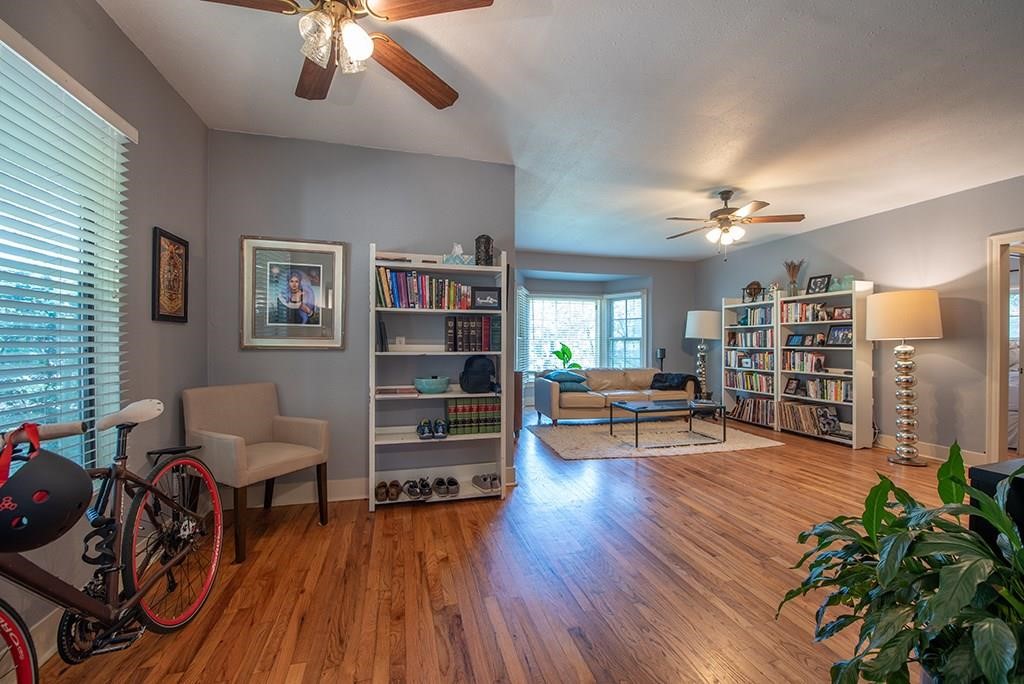 a living room with furniture and wooden floor