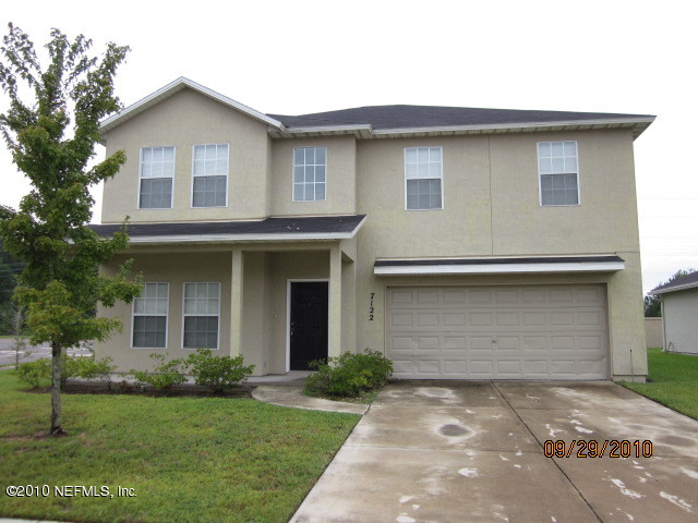 7122 Rampart Ridge Circle West Jacksonville, FL 32244 - Photo 1 of 1 a front view of a house with a garden and yard