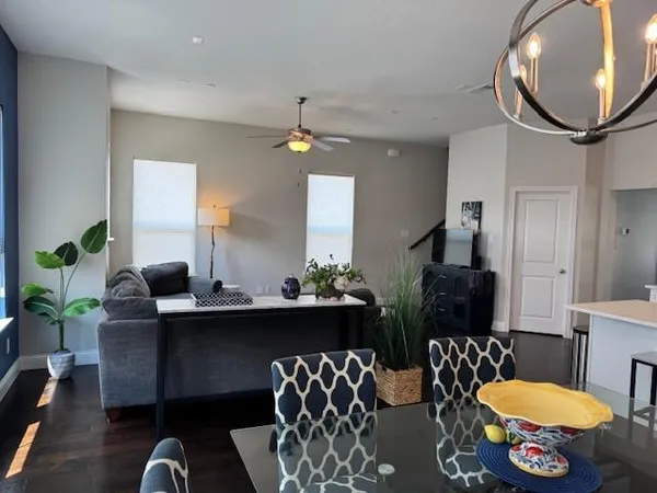 a living room with furniture a chandelier and a mirror