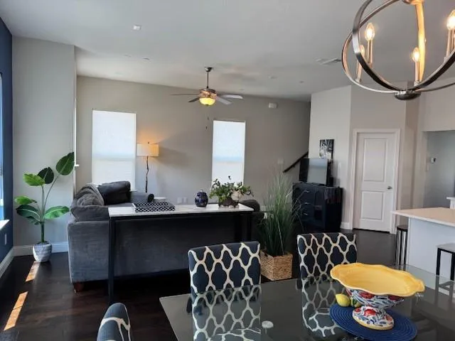 a living room with furniture a chandelier and a mirror