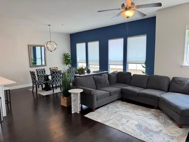 a living room with furniture and wooden floor
