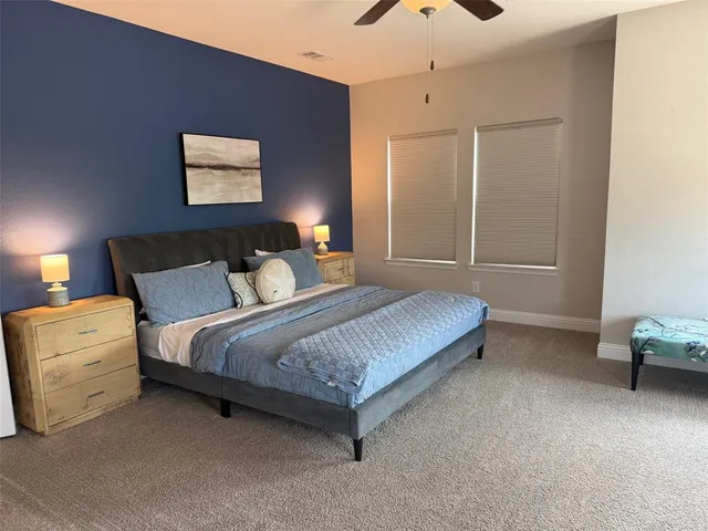 a bedroom with a bed and a chair