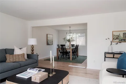a living room with furniture and a dining table