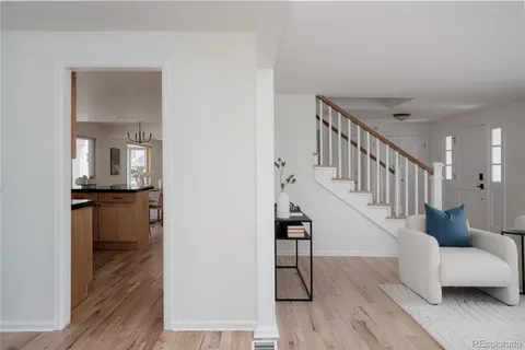 a view of entryway and hall with wooden floor