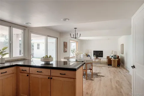 a kitchen with a sink and living room view