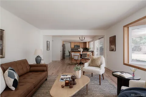 a living room with furniture a rug and a window