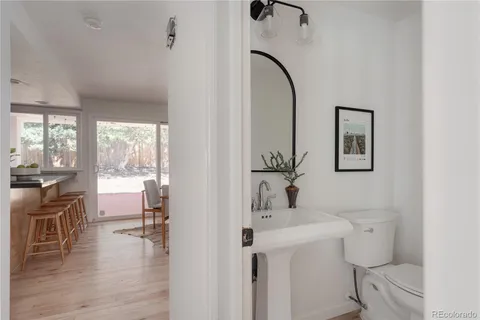 a bathroom with a sink toilet and a mirror