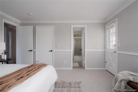 a bedroom with a bed and a mirror