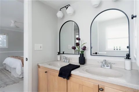 a bathroom with a double vanity sink and a mirror