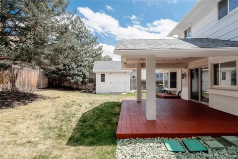 a view of a house with backyard and sitting area