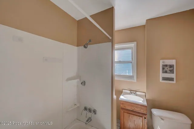 a bathroom with a glass door shower