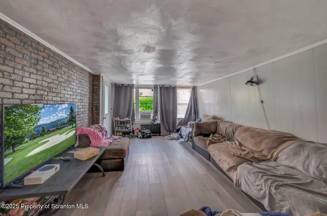 an empty room with wooden floor and closet