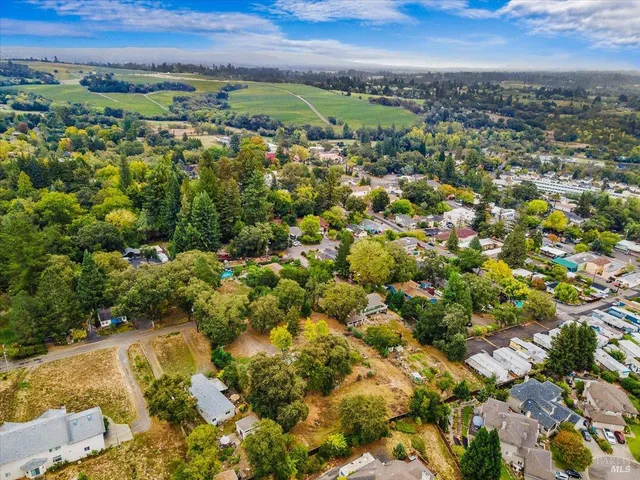 an aerial view of a house with a yard and garden