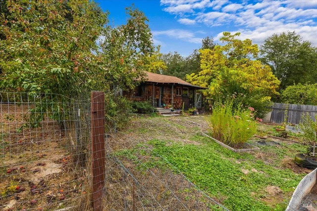 a view of a garden with a house