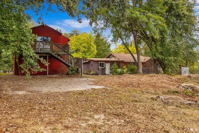 a front view of house with yard and trees