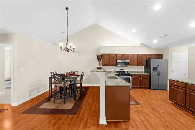a large kitchen with a table and chairs